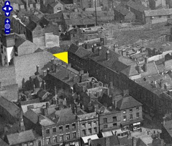 The yellow triangle shows the approximate site of the demolished Bull's Head and Greyhound pubs in this image from Britain From Above.