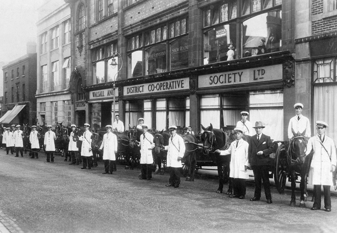 The milkmen of the Co-op posing with their trusty steeds outside the main offices and store in Upper Bridge Street. This picture was probably taken around 1937 when the new dairy in Midland Road was opened.